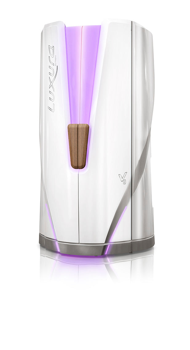 Luxura V8 vertical tanning booth with a glossy white exterior and soft purple ambient lighting along the centre panels and base.