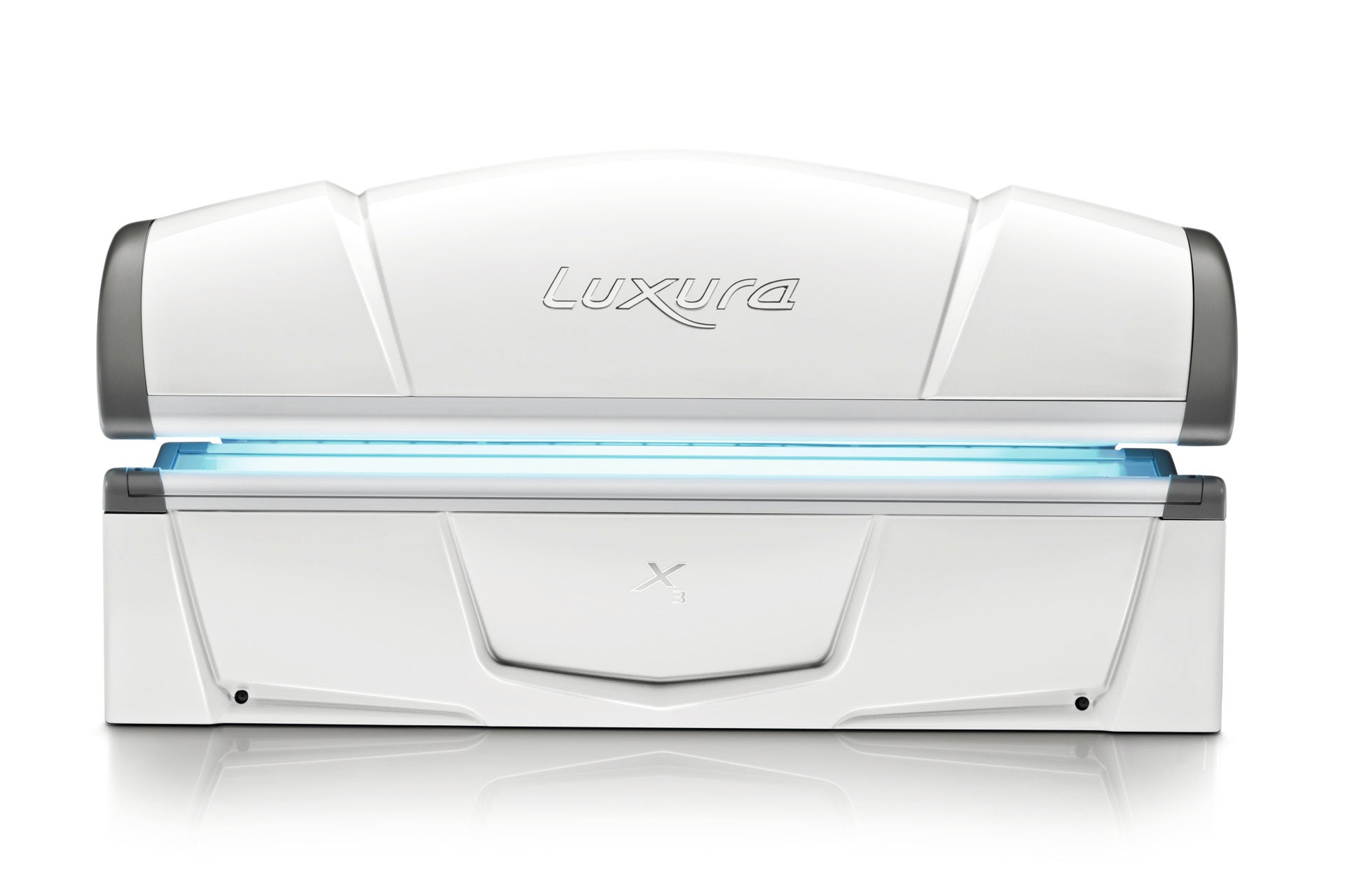 Front view of the closed Luxura X3 tanning bed with an aqua-coloured lamp glow beneath the canopy.