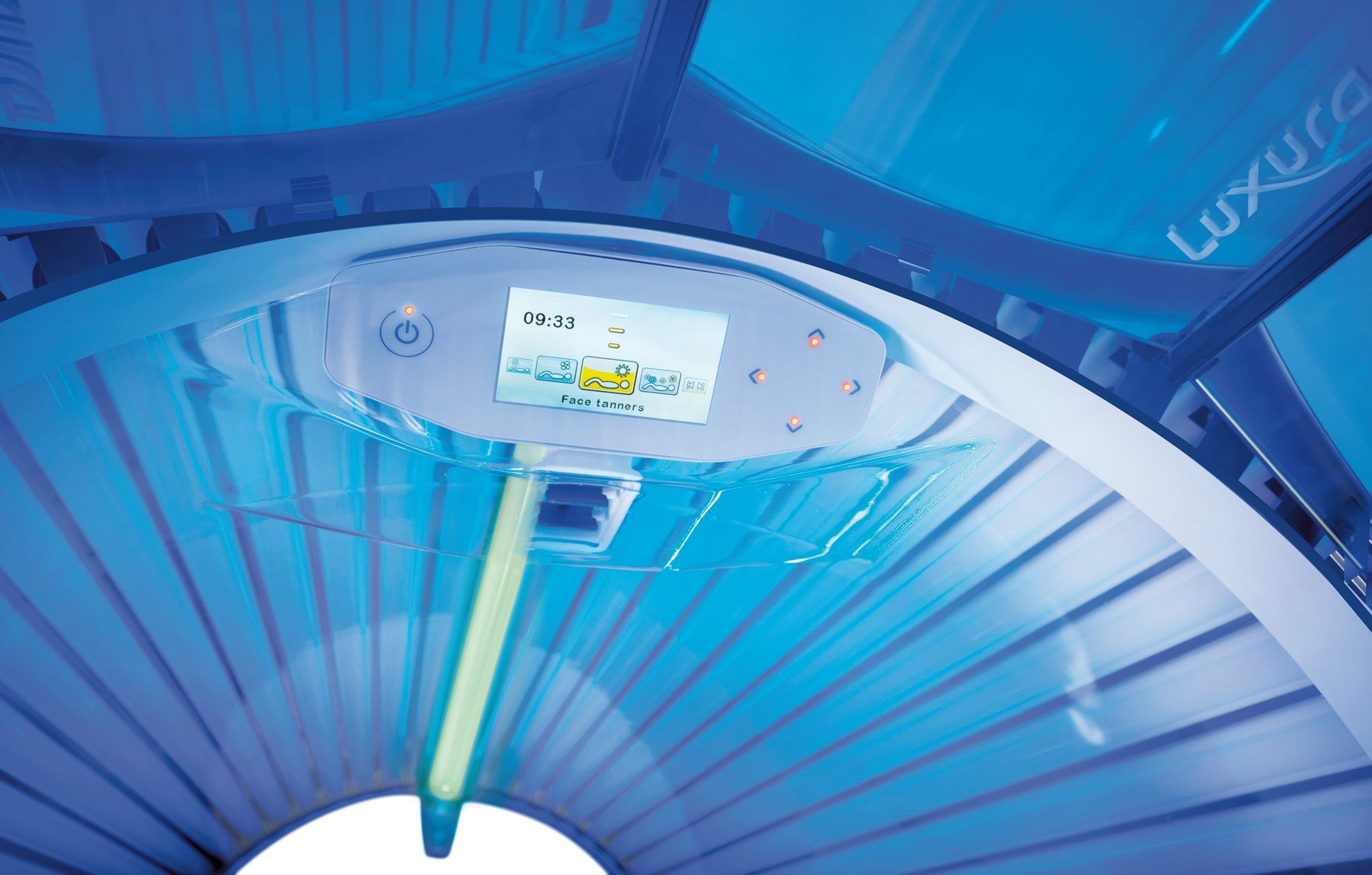 Close-up of the Luxura X7 touchscreen-style display showing session controls, cooling icons, and illuminated navigation buttons.