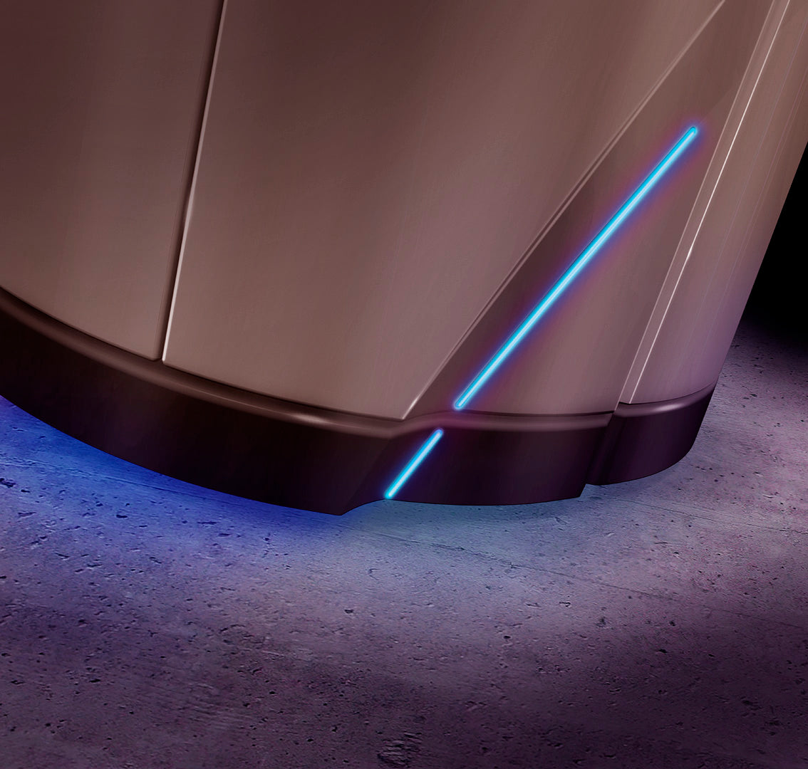Close-up of the Luxura V8 sunbed base showing blue LED accent lighting glowing along the lower panels and onto the floor surface.