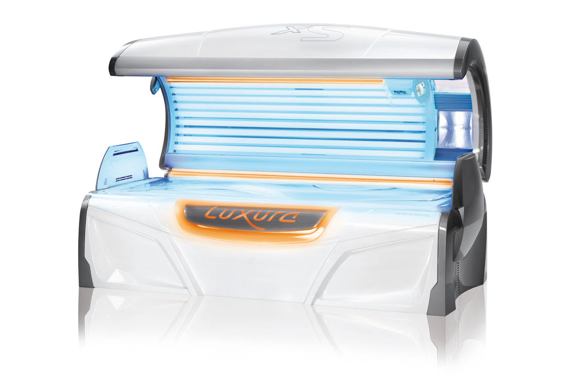 Luxura X5 tanning bed shown fully open with bright blue tanning tubes and warm orange DecoLight illumination along the frame.